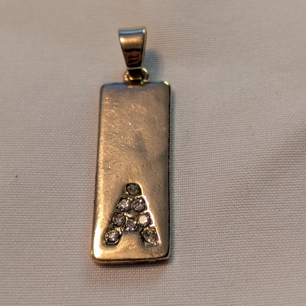 Gold Tone Pendant with Crystal Accents.